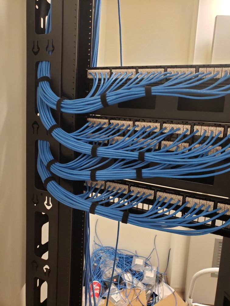 Neatly dressed and labeled patch panel cabling after a Capilano Communications cleanup