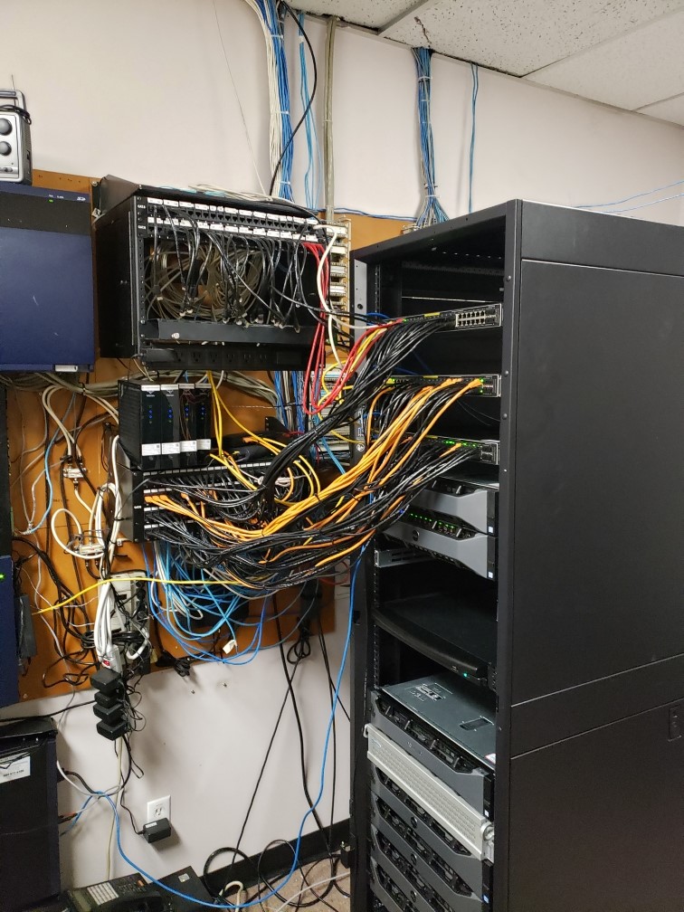 Disorganized rack wiring before a Capilano Communications rack cleanup